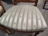 a chair with a striped seat and a wooden frame
