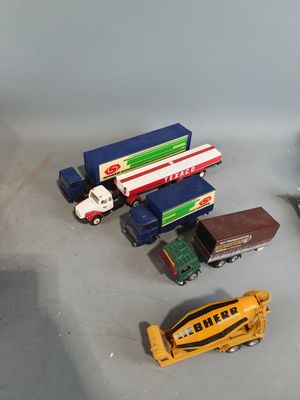 a lot of toy cars and trucks that are on the table