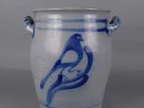 a blue and white vase with a bird on it