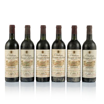 six bottles of wine are lined up on a white surface