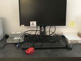 a computer desk with a keyboard, mouse, and monitor on it