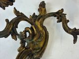 pair of antique brass wall sconces in the shape of a peacock