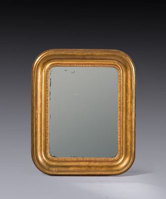 an antique gold framed mirror with a black background
