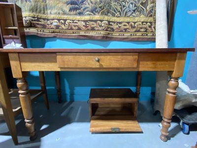 a wooden table with a drawer underneath it in a room