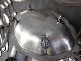 a silver plate with spoons and silver spoons on it