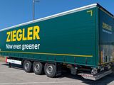 a large green semi truck parked in a parking lot