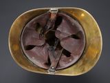 an old helmet with a propeller on top of a black surface