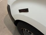 a white truck with a sticker on the front of it