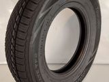 someone is holding a tire on a white surface with a white background