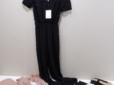 black lace jumpsuits, pink shirt and black pants on a hanger