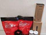 the contents of the whey protein package are laid out on the counter