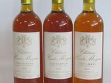three bottles of wine sitting next to each other on a white surface
