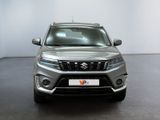 the front view of a silver suv parked in a white room