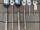 four different types of drill bits are on display in a store