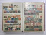 an open book with stamps on it on a table