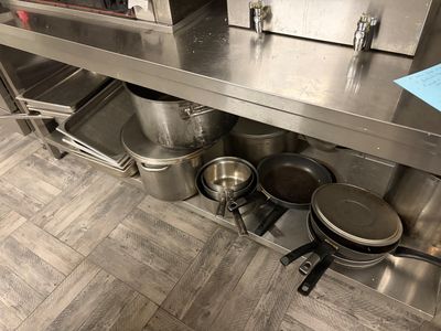 les nombreuses casseroles et poêles qui se trouvent sur le plan de travail de la cuisine