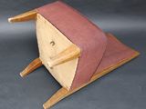 a small wooden chair with a pink seat on it