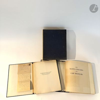 two open books sitting on top of each other on a table