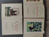 three books are sitting on a table next to each other