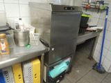 a kitchen with a stove, sink, and other items on the counter