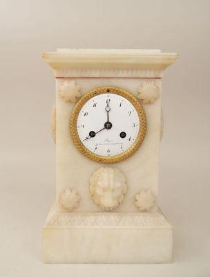 a clock that is sitting on a pedestal on a white background
