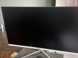 a flat screen tv sitting on top of a wooden table