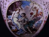 a large vase with a painting on it sitting on a table