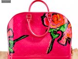 pink louis vuitton handbag with roses on it sitting on a box