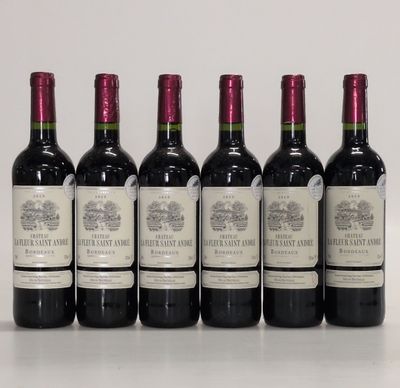 six bottles of wine are lined up in a row on a table