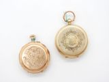 two gold lockes on a white surface one has a picture of a woman and the other has a picture of a man