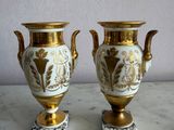 two vases that are sitting on a marble table