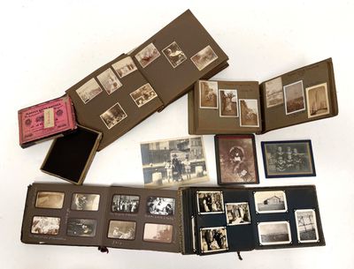 several old photos of people are displayed in a box on a white surface