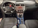 a dashboard of a small car with a steering wheel