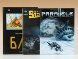 deux livres posés sur une table, avec une image représentant un vaisseau spatial et une planète