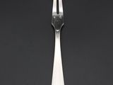 fork and knife on a black table with a black background