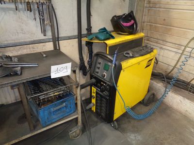 a welding machine that is sitting in a garage