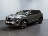a silver suv parked in a room with a black floor