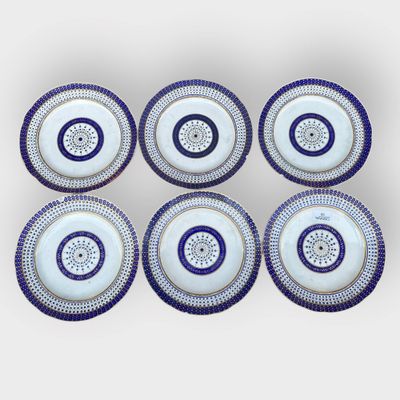 six blue and white plates with circular designs on them
