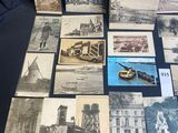 several old black and white photographs of people and buildings on a table