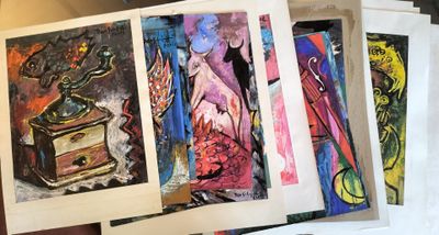 four paintings on a table with a person holding one of them
