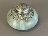 a small silver object sitting on top of a table