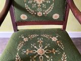 a green chair with a floral design on it