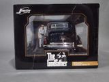 boxed box of a black toy car with a man standing next to it