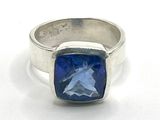 silver ring with a blue stone in the center