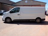 a white van parked in front of a building