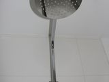 a shower head that is attached to a pole in the bathroom