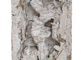 an image of a sculpture of a man on a rock