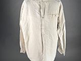 a white shirt on a black mannequin stand with a gray background