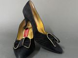 pair of women ' s black shoes with a bow on the toe