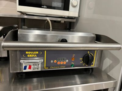 stainless steel counter top with oven and microwave on it in a commercial kitchen